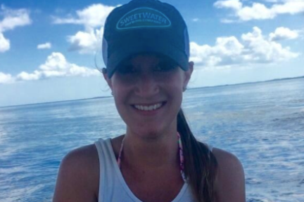 a person holding a fish in the water